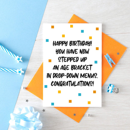 Birthday Card by SixElevenCreations. Reads Happy Birthday! You have now stepped up an age bracket in drop-down menus. Congratulations! Product Code SE1401A6
