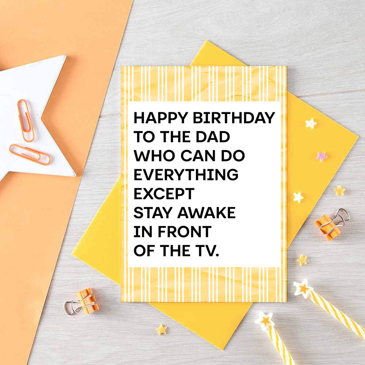 A birthday card for dad featuring a white center with bold black text that reads, 'HAPPY BIRTHDAY TO THE DAD WHO CAN DO EVERYTHING EXCEPT STAY AWAKE IN FRONT OF THE TV.' The card has a yellow and white striped border. Designed by SixElevenCreations. Product Code SE2304A6